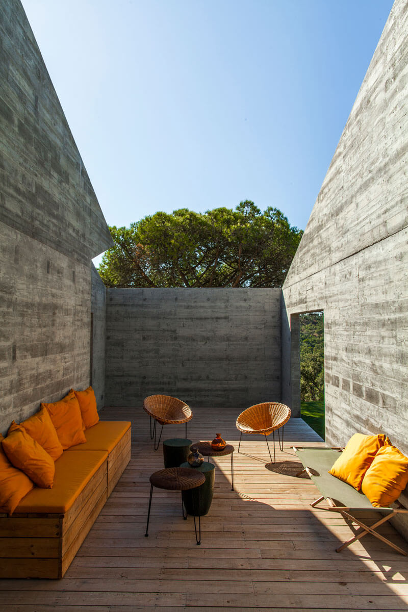 6b-. Patio en el interior de la casa principal, con suelo de madera con juntas abiertas, para disfrutar del azul del cielo enmarcado por la estructura de hormigón