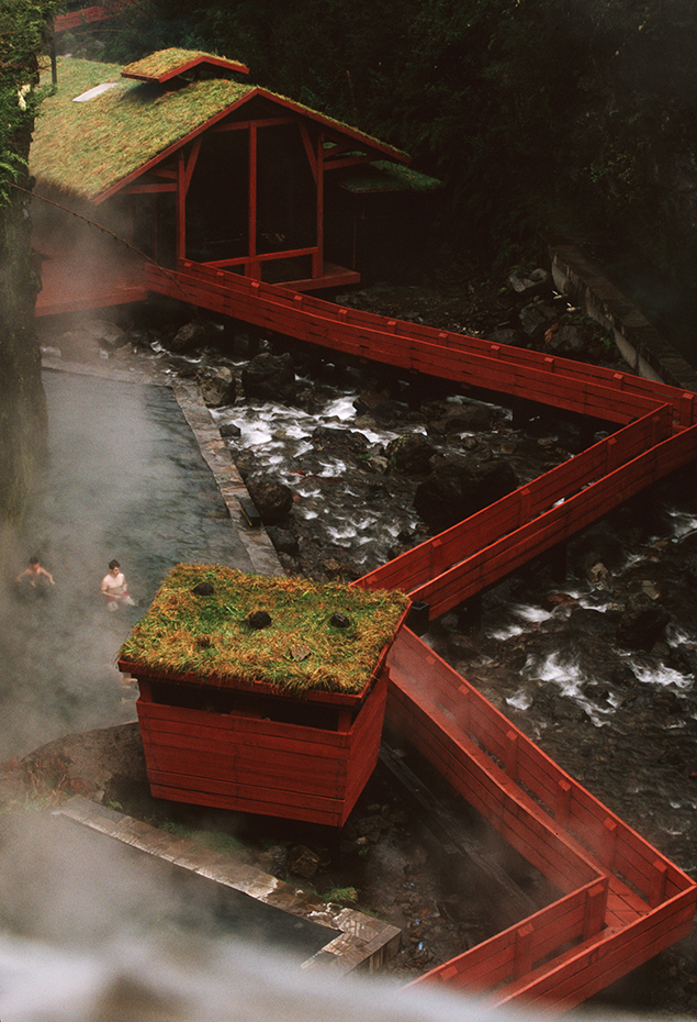 Germán del Sol Termas Geométricas aerial detail. La pasarela de madera roja de las Termas Geométricas serpentea por 17 piscinas de aguas termales a lo largo de 450 metros, creando una poderosa armonía entre naturaleza y diseño