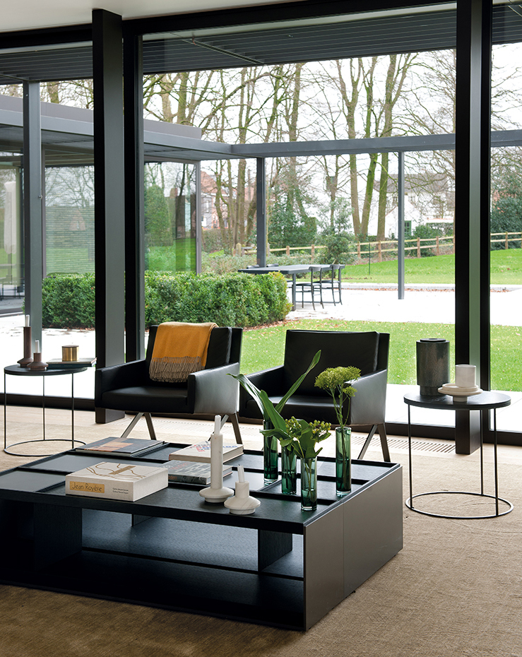 00377868 ok. Las butacas Theo y la mesa de centro Surface del salón son un diseño de Vincent van Duysen para B&B Italia. Mesillas auxiliares Circus, de Janine Vandebosch para Interni Edition
