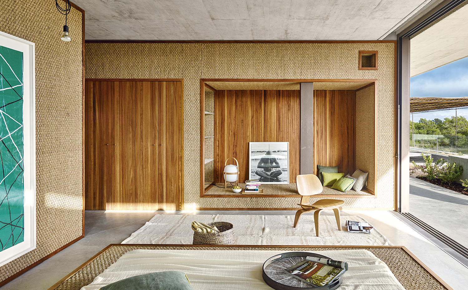 00395137 ok. Junto al dormitorio principal se ha habilitado un acogedor rincón de lectura. Silla Plywood, de los Eames, editada por Vitra. Sobre la cama, una bandeja de CoriumCasa