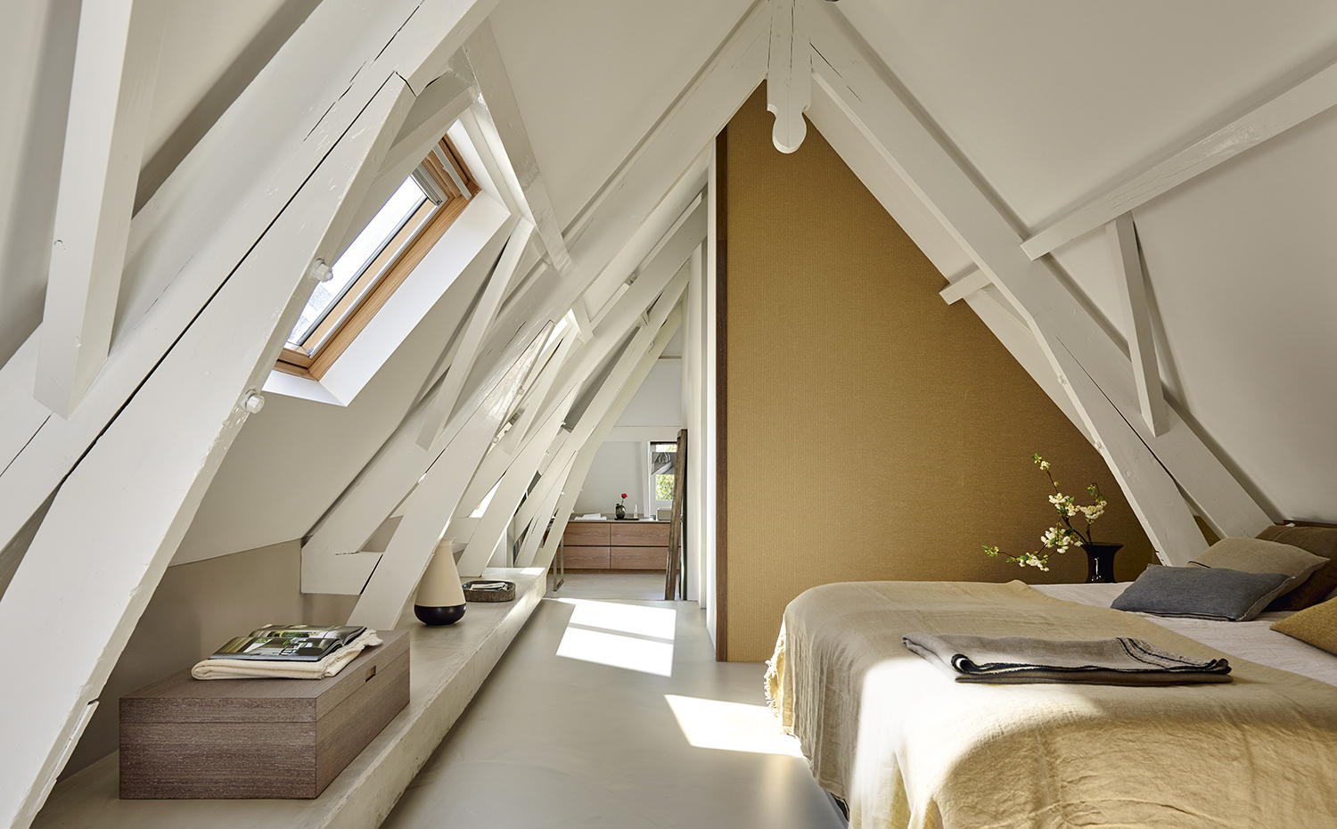 00407717 ok. Cama Nobel, de Nilson Beds. Mantas y cojines, de Teixidors, Maison de Vacances y Avec. Sobre el estante de hormigón, jarrón de cerámica bicolor, de Piet Hein