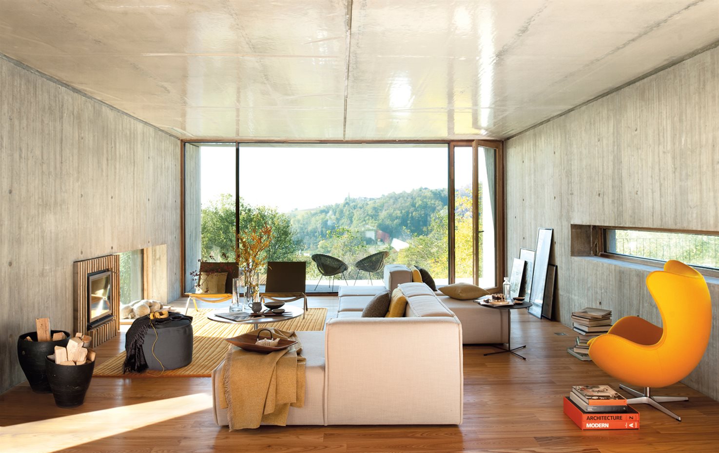 00375315. Contra la cristalera, dos butacas PK22, de Poul Kjaerholm para Fritz Hansen. Sofá de BoConcept. Alfombra Dune, de Paola Lenti