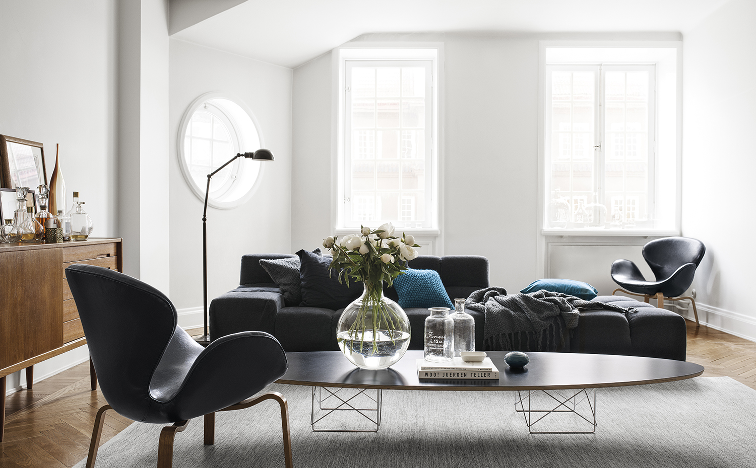 En casa de H&M 11. Butacas Swan, de Arne Jacobsen para Fritz Hansen. La mesa de centro es la Elliptical ETR, de Charles & Ray Eames, editada por Vitra. Sobre el sofá Tufty Time, diseño de Patricia Urquiola para B&B Italia, cojines de H&M