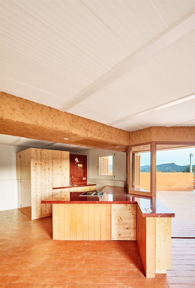 Can Migris. La disposición de la cocina se ha hecho para aprovechar al máximo el espacio, por lo que el mobiliario se ha hecho a medida con acabados de paneles de madera de pino sin tratar.