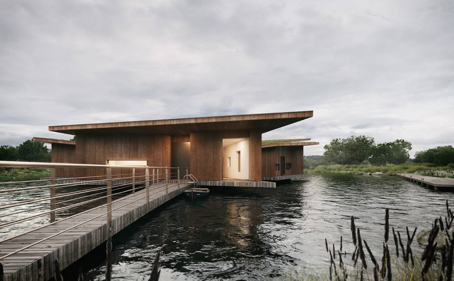 Pasarela de madera, acceso vivienda, barandilla de acero, vivienda sobre estanque, entorno rural. En contraste con las amplias vistas sobre el embalse que disfruta gran parte de la casa, el área más septentrional y de acceso a la vivienda queda más protegida, para una mayor privacidad. 