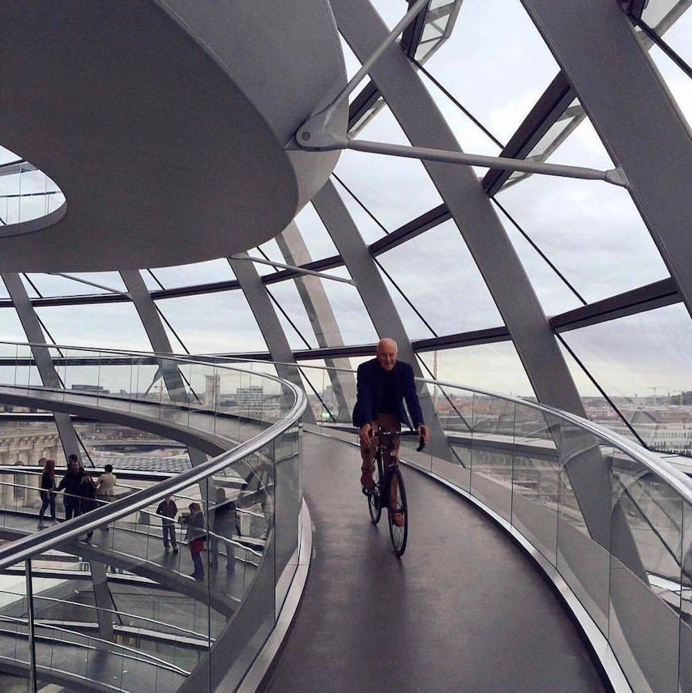 Norman Foster bajando en bicicleta por una de las rampas del Reichstag, en Berlin