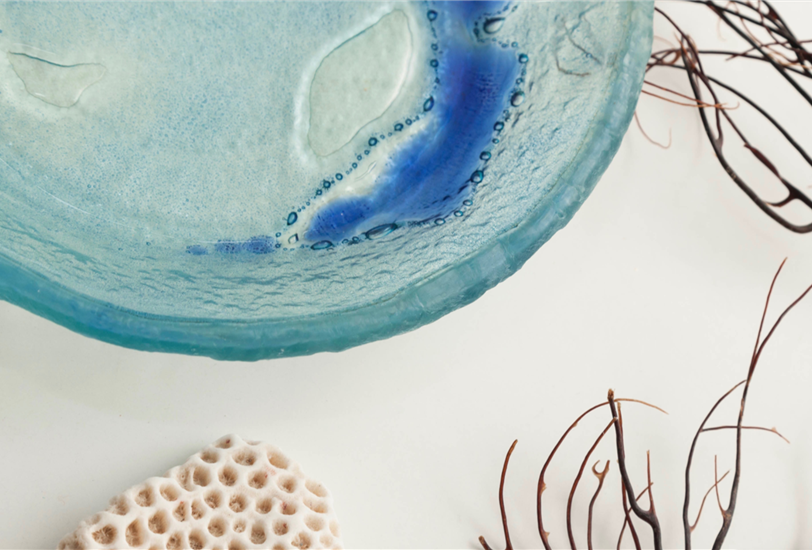 La colección Ola la forman platos y bandejas de simetría irregular y carácter expresionista con una aguada en color cobalto.
