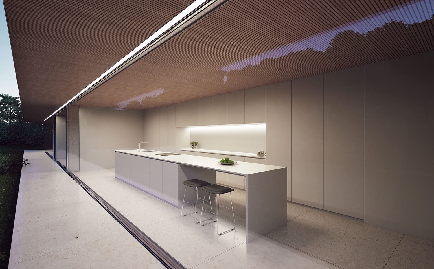Cocina con amplio frente de almacenaje, totalmente integrado en blanco, con superficie de trabajo iluminada indirectamente, isla con office y taburetes metálicos y asiento negro