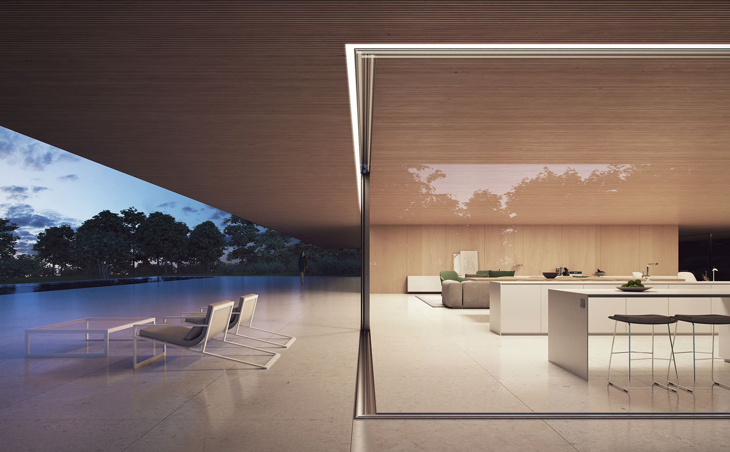 Perfil del cerramiento de cristal con bajocubierta con listones de madera, pavimento de baldosas en interior y exterior, butacas con mesa de exterior, taburetes en zona de office, isla de trabajo y sofá gris