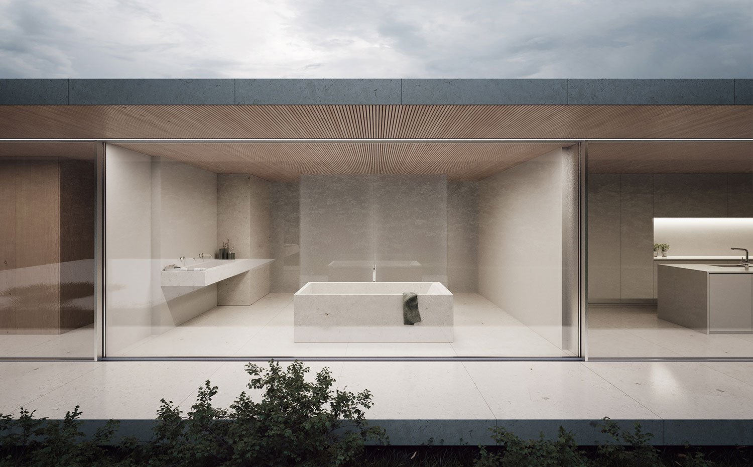 Vista de baño desde exterior con bañera exenta de piedra, encimera suspendida de piedra con doble lavabo, ducha tras hoja de cristal translúcido, revestimiento de paredes y suelos de piedra