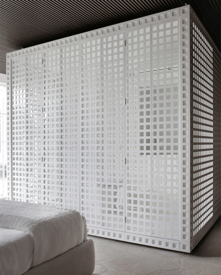 Cuarto de baño a modo de cubícuo blanco con estructura metálica perforada. Todo ello a pie de cama.jpg