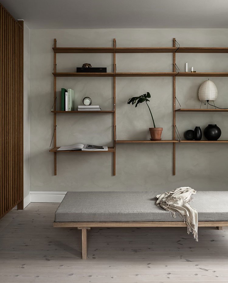 Bancada en madera y gris junto a mueble ligero de madera suspendido en pared, pavimento de madera 