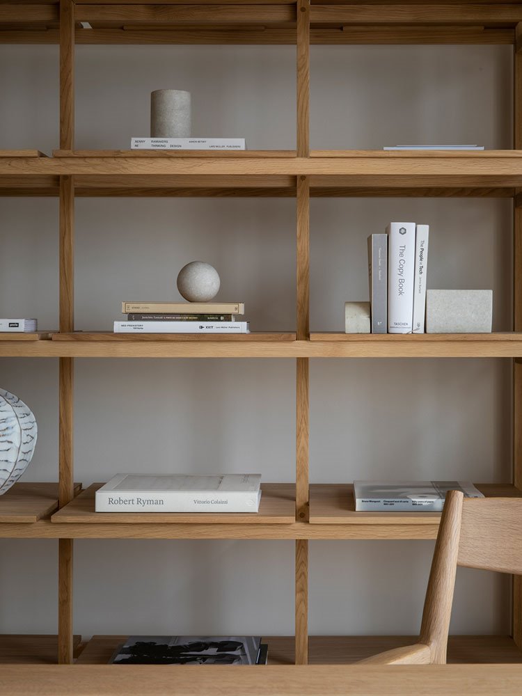 Estantería de madra con libros y detalles en piedra 