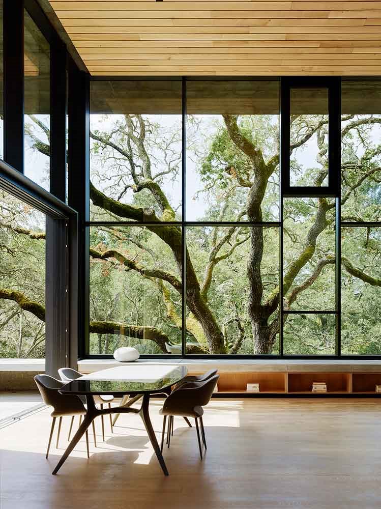mesa-y-sillas-con-vistas-al-arbol-en-la-casa-Miner-Road-de-Faulkner-Architects