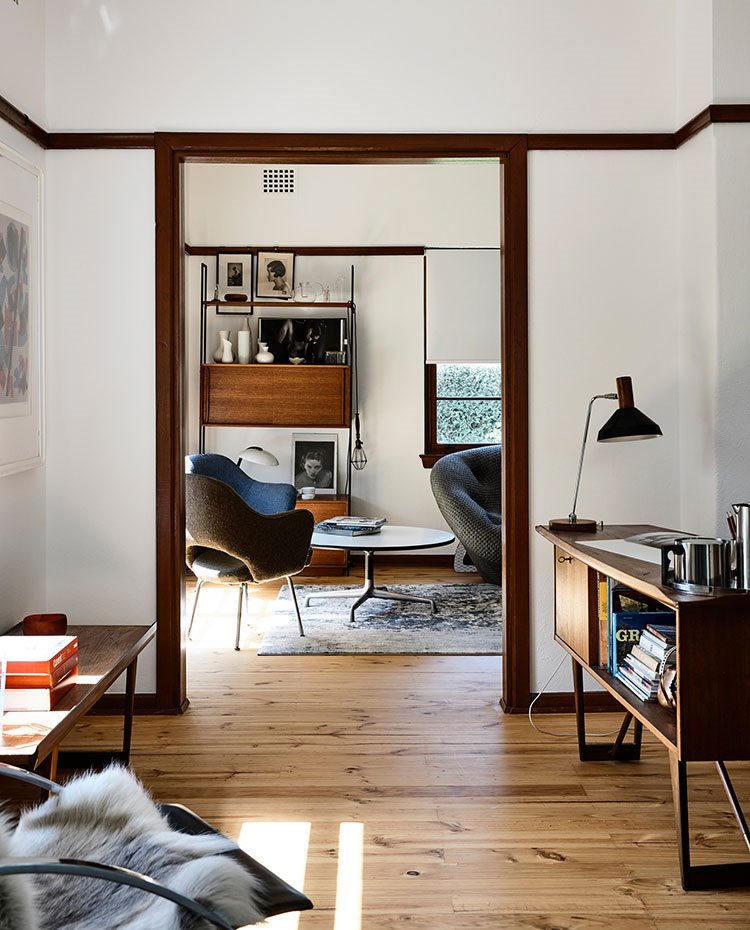 Zona-de-estudio-y-sala-de-estar-con-mobiliario-de-aire-retro-y-perfilería-de-madera