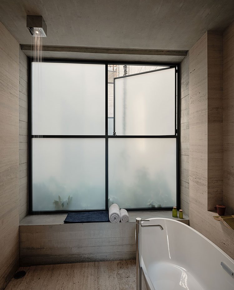 Cuarto de baño con bañera exenta y ducha, repisa para asiento de obra