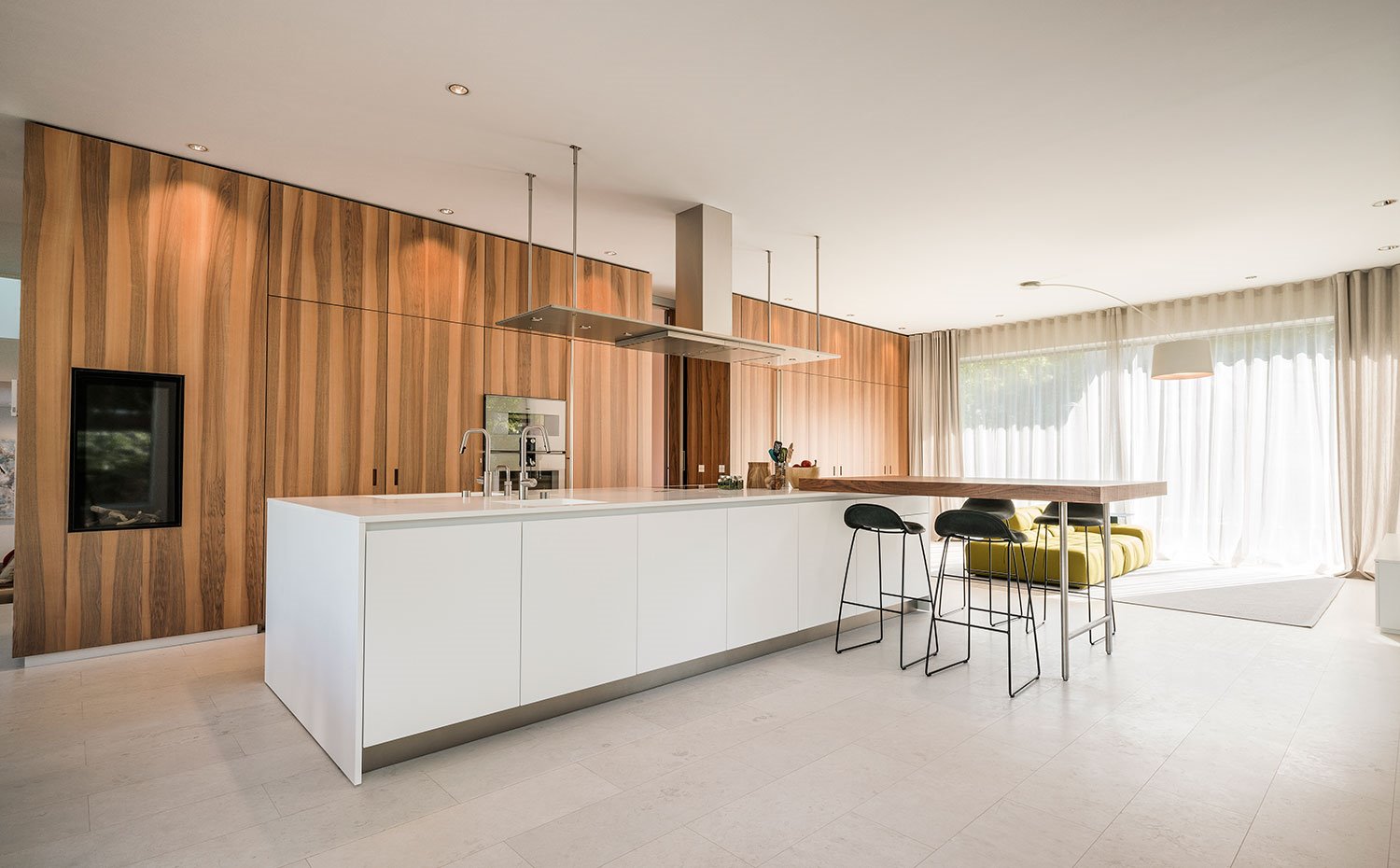Cocina con amplia isla de trabajo blanca y office