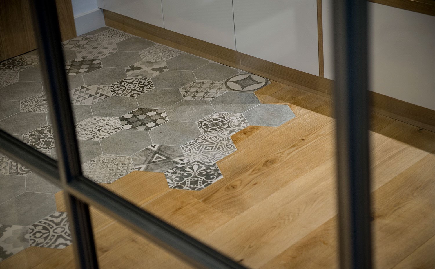 Detalle suelo con madera y revestimiento cerámico en forma de hexágono en blanco y negro
