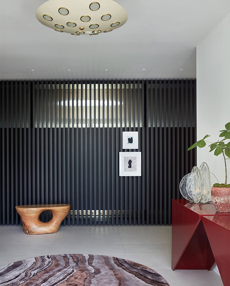 Luminaria de texo semicircular, asiento en madera, consola lacada en rojo, panel en listones en negro