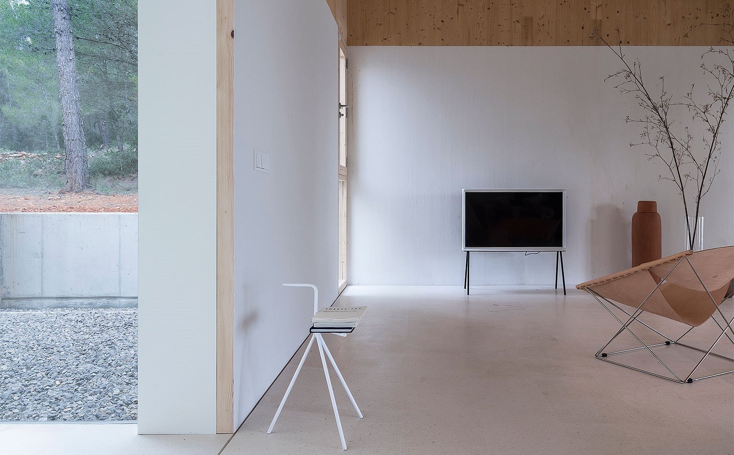 Zona de estar con ambiente en blanco y techos en madera