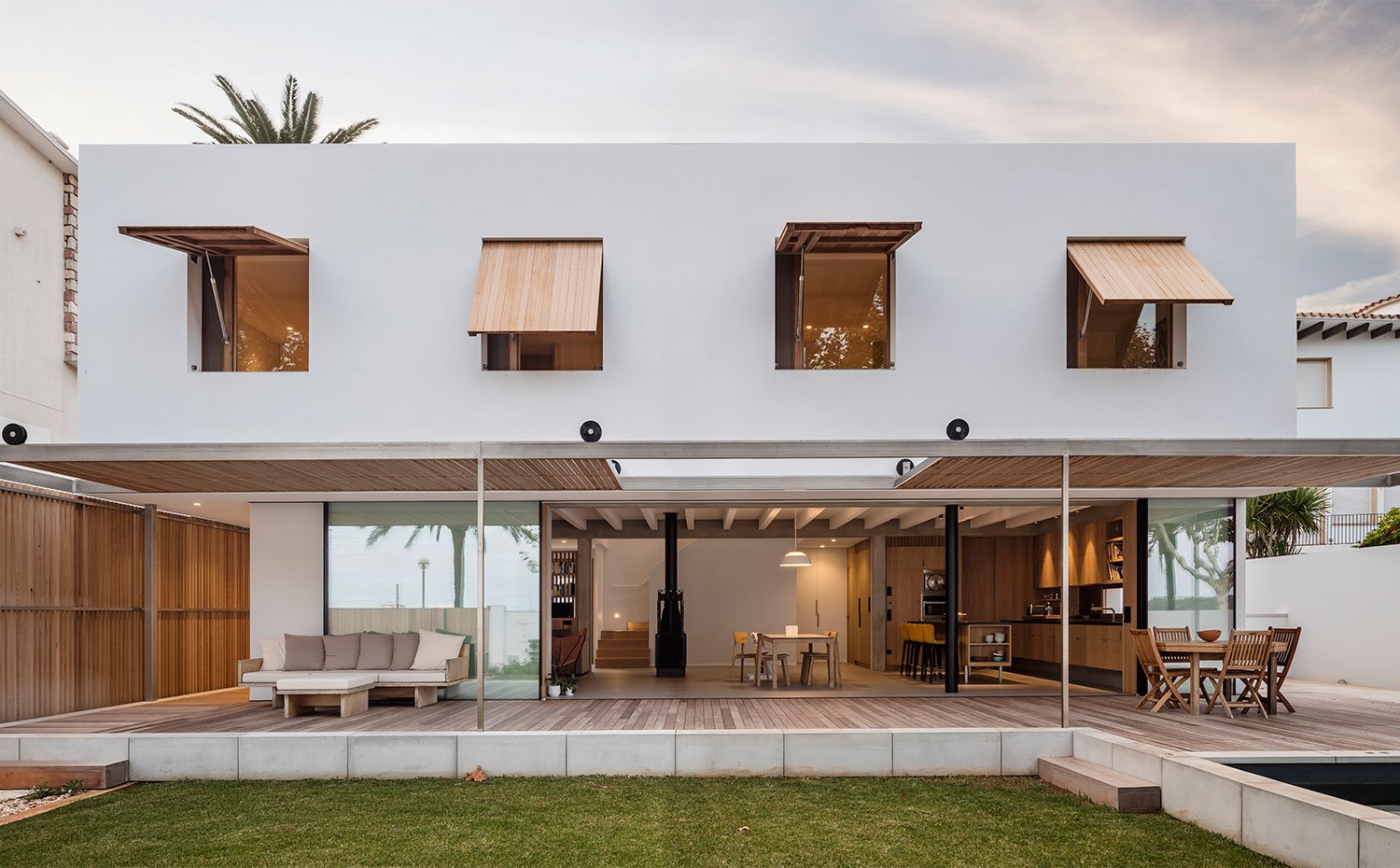 Vista general exterior de fachada con cerramientos de madera y casa abierta