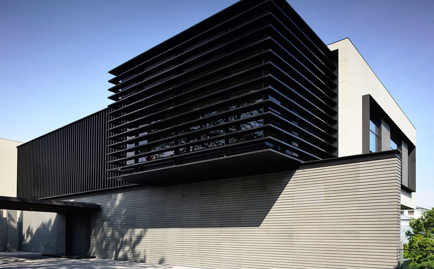 Estructura con fachada ventilada en tonos claros y oscuros.