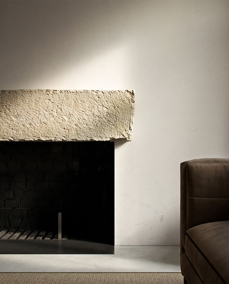 Chimenea con sobre de hormigón, sofá gris
