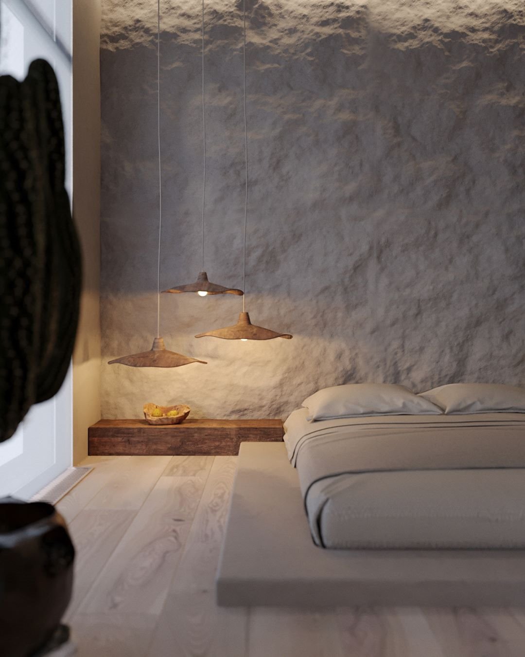 Dormitorio con paredes rugosas y lamparas suspendidas