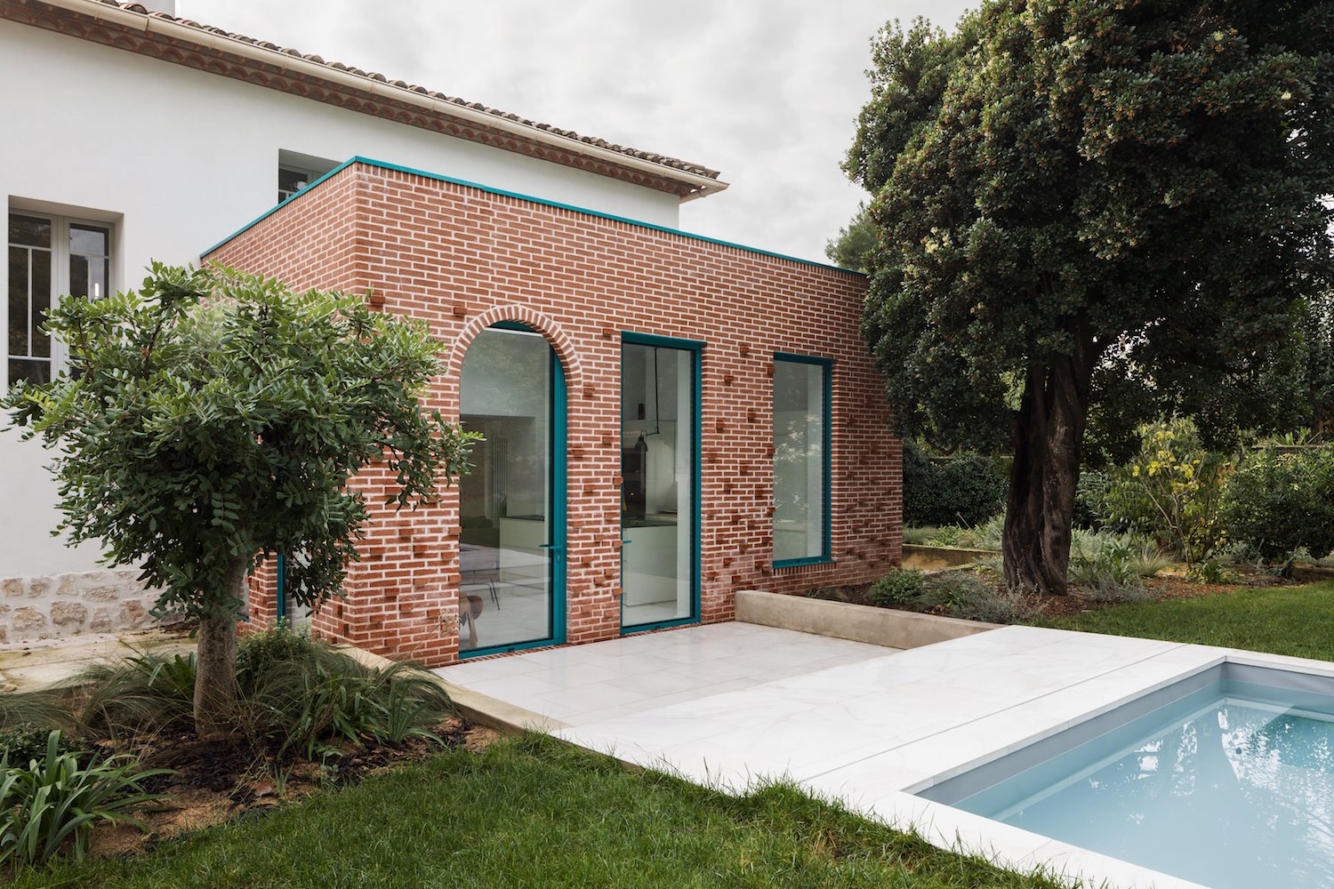 Bloque de ladrillo junto a una piscina en una casa moderna