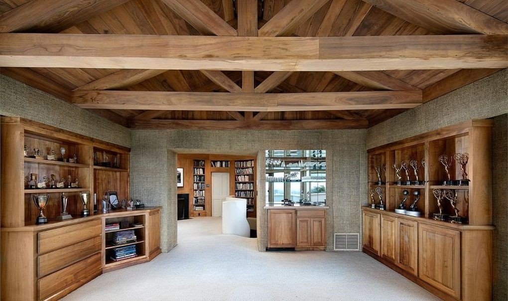 Casa katharine Hepburn comprada por LeBron James sala con vigas de madera y estanterías