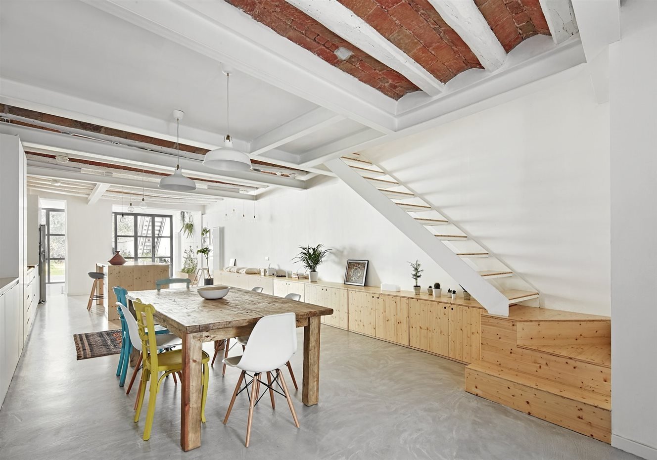Comedor con doble altura y vigas de madera