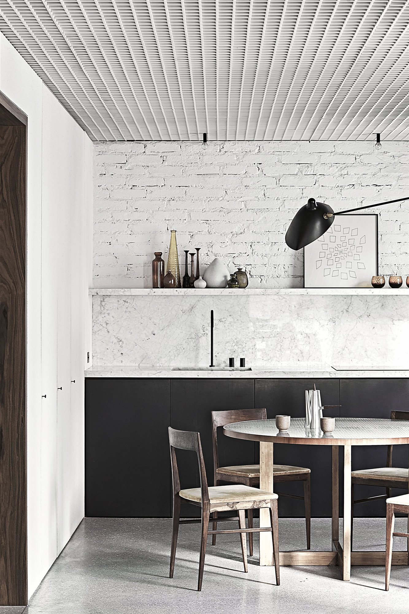 Cocina con pared de ladrillo blanc y mesa de comedor de madea copia
