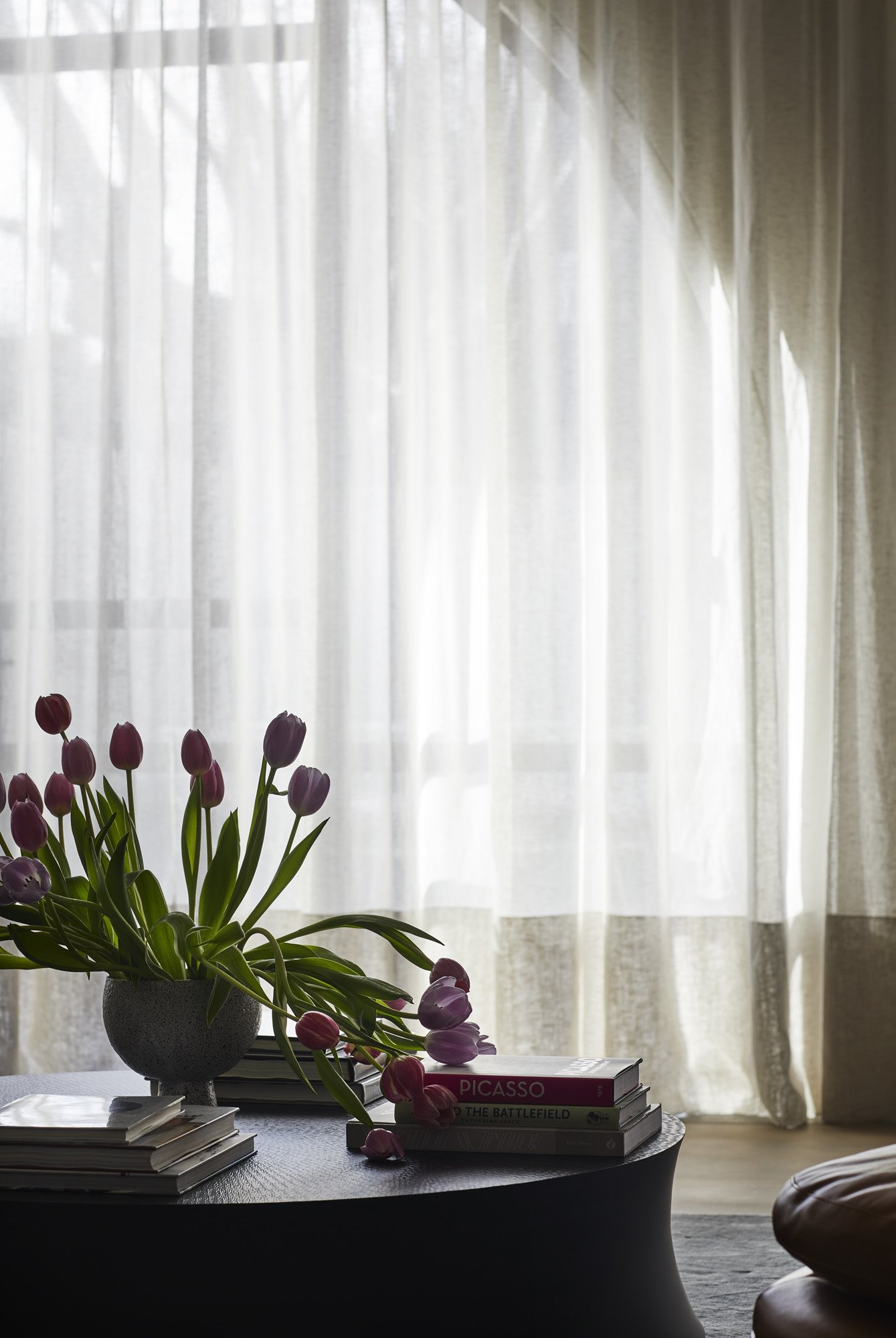 Mesa con tulipanes y cortinas de color blanco
