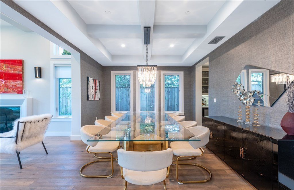 Casa de Ariel Winter la actriz de la serie Modern Family comedor con mesa de cristal y sillas blancas con patas doradas