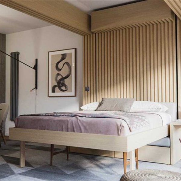 Un sofá muy moderno que se transforma en cama bajándolo del techo