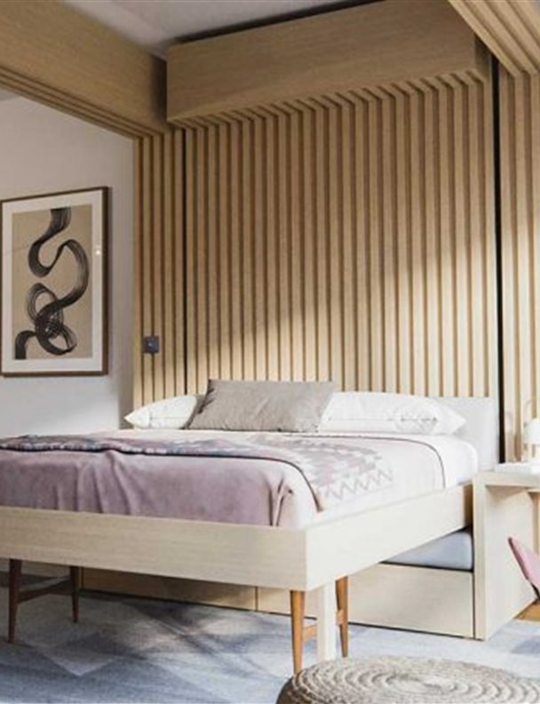 Un sofá muy moderno que se transforma en cama bajándolo del techo