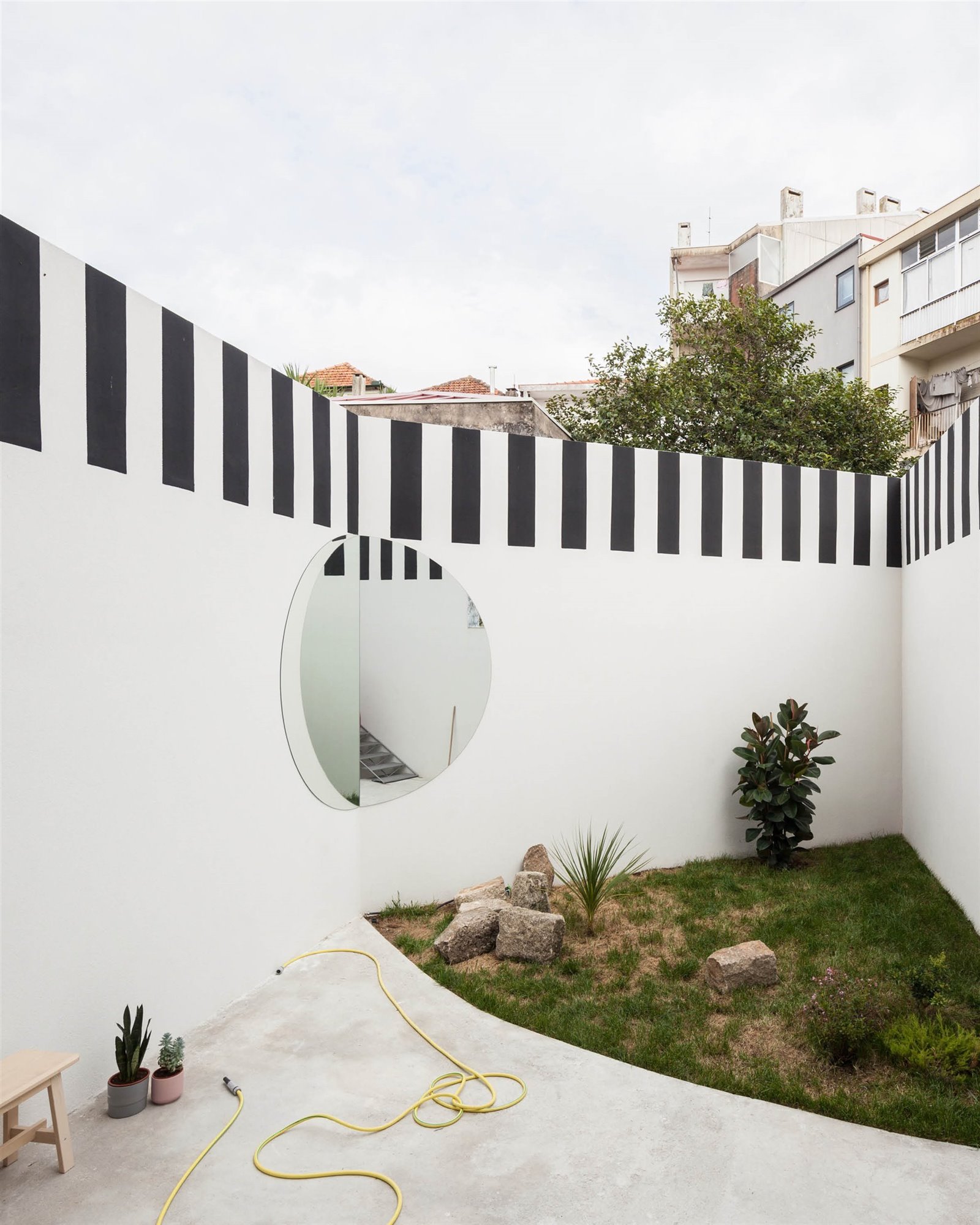 Patio pintado en color blanco y negro de un piso reformado por Fala Atelier en Portugal