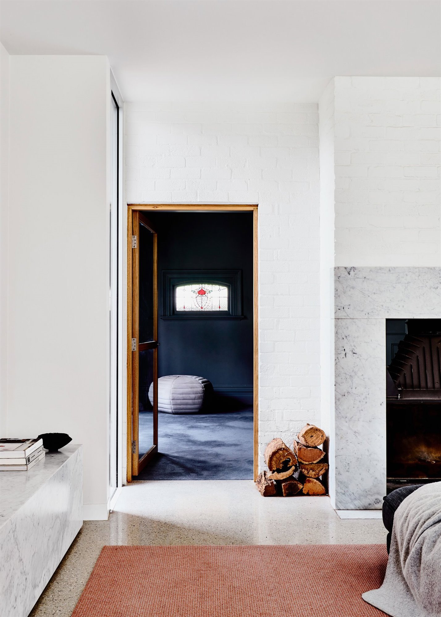 Salon con chimenea de piedra de una casa en Australia
