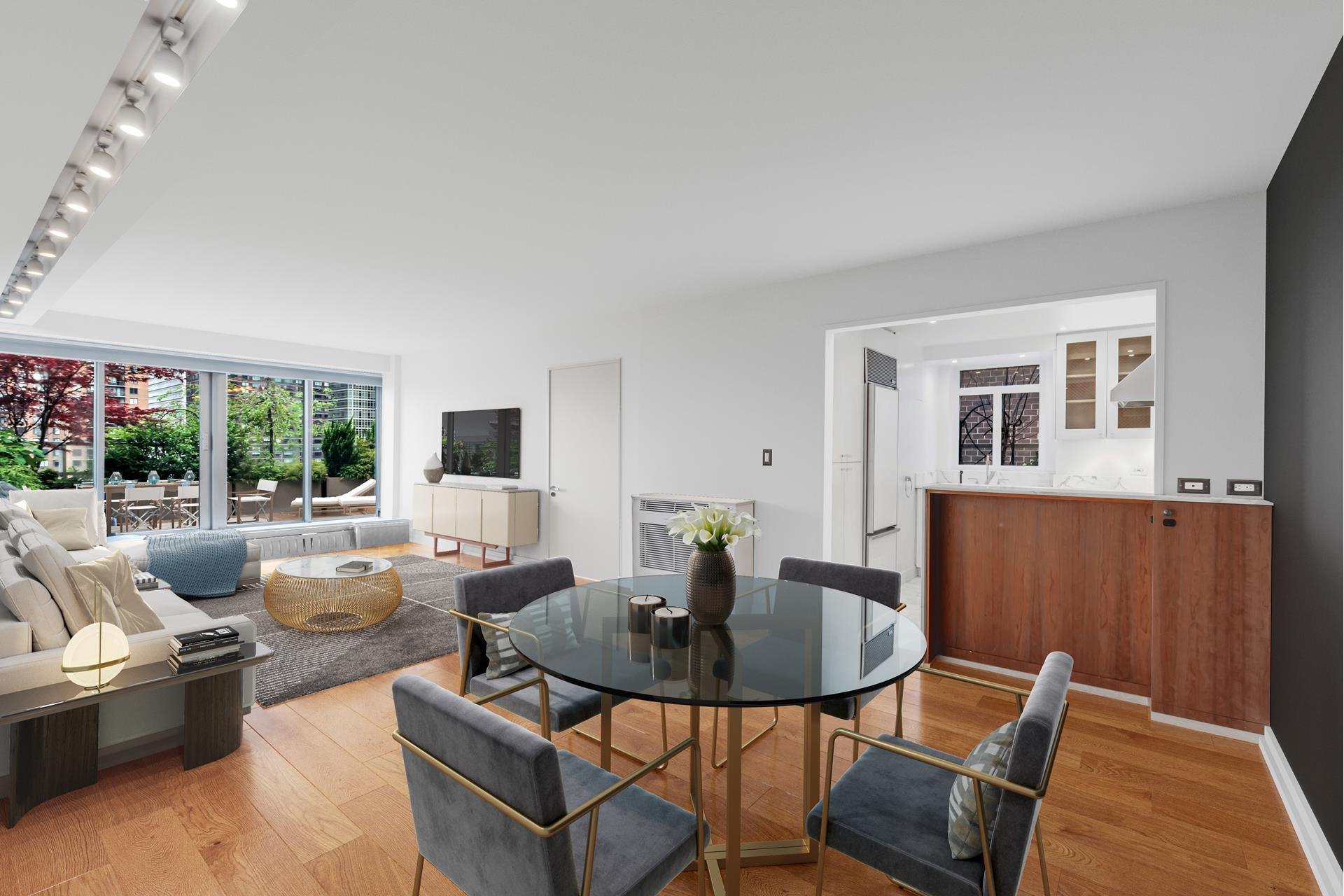 Salon comedor con sofas de color gris y mesa redonda con sillas de la casa de Scarlett Johansson en Nueva York
