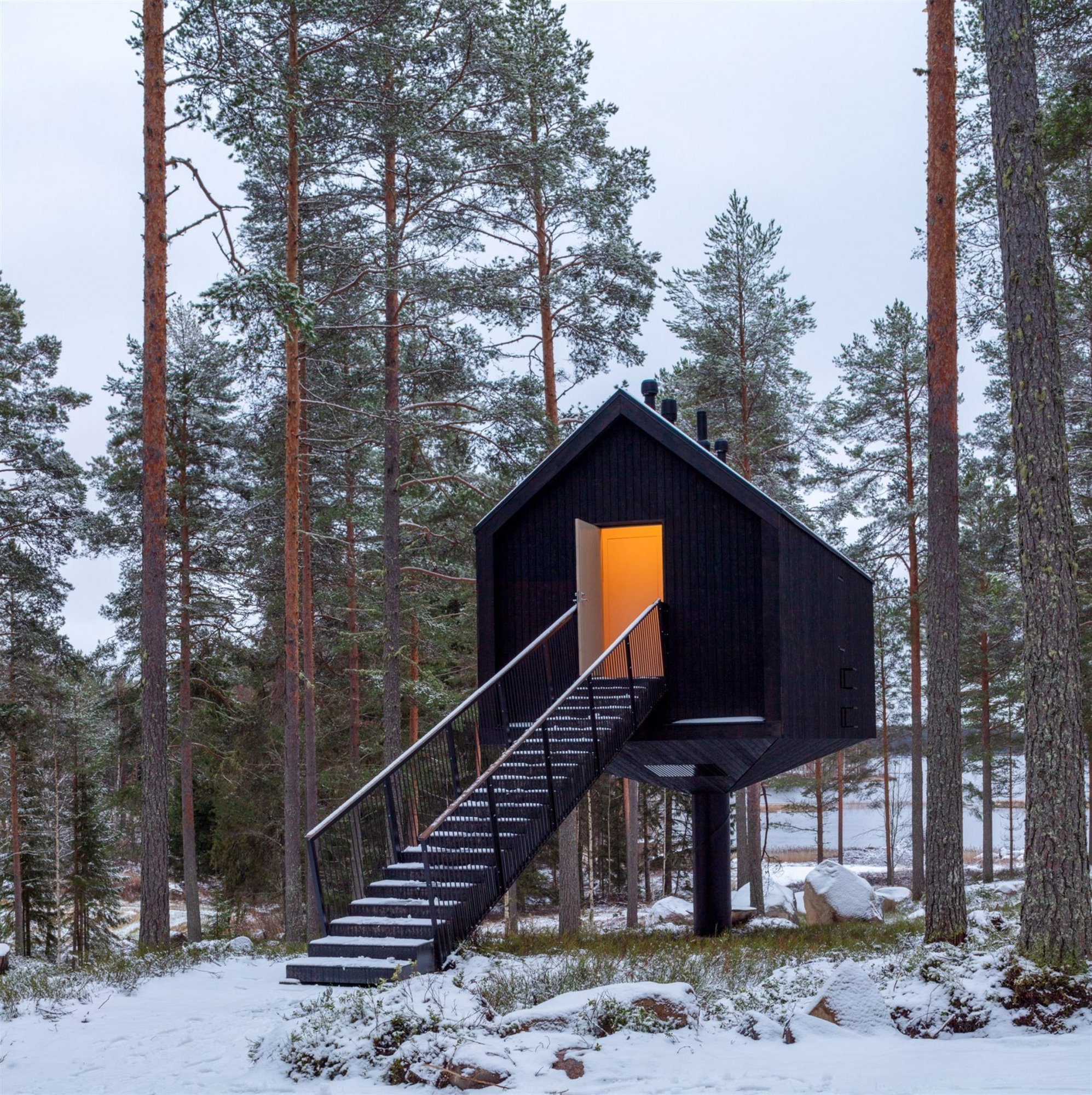 Cabaña en las montañas de Finlandia en el bosque nevado