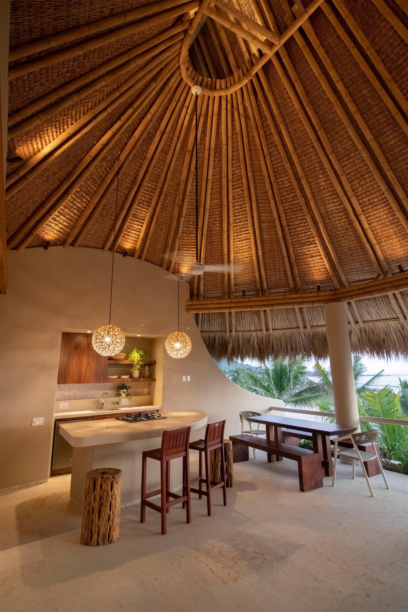 Casa en la playa con interiores de color ocre interior con techo de paja