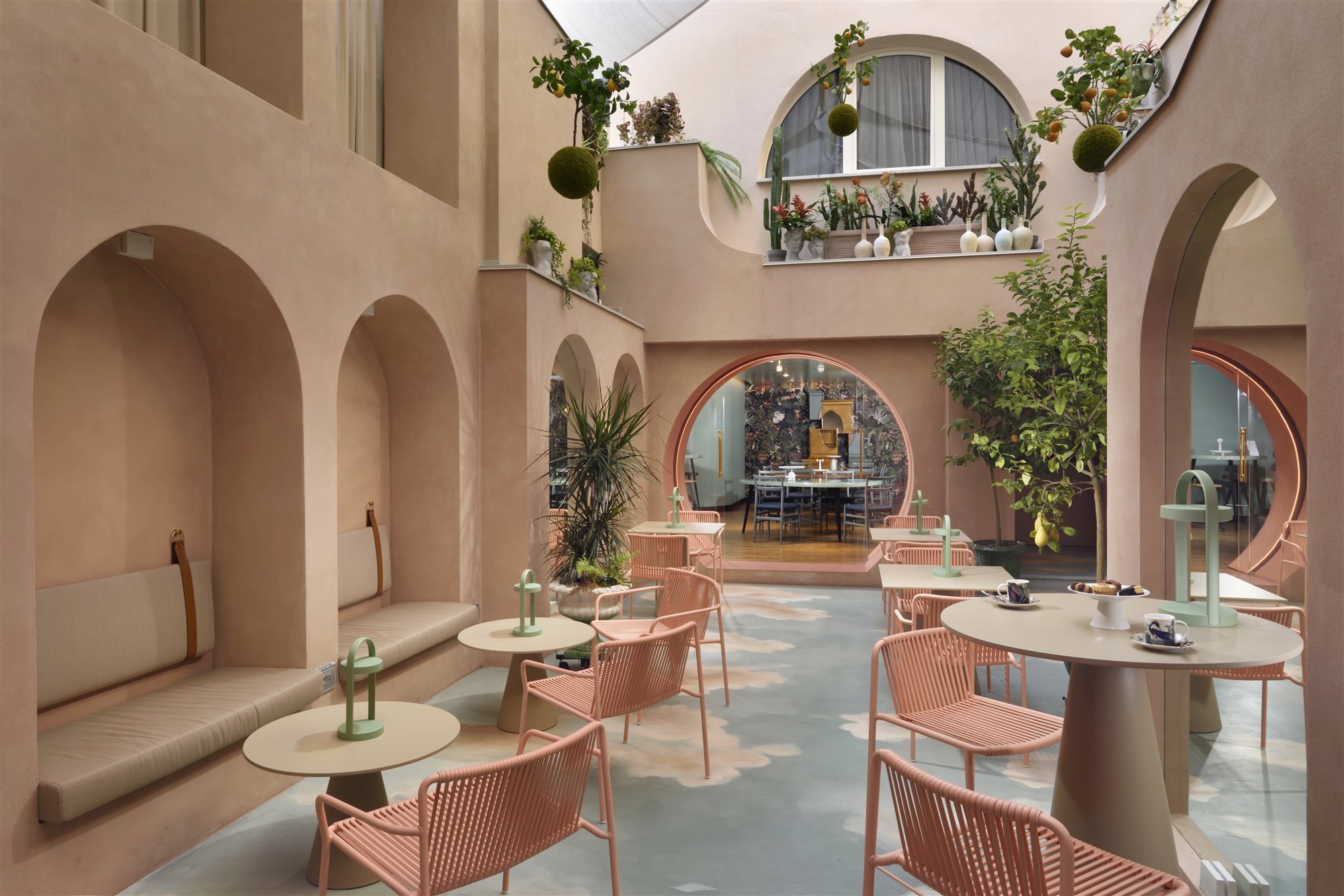 Patio con arcos de color rosa del hotel Leon Place en Roma 5