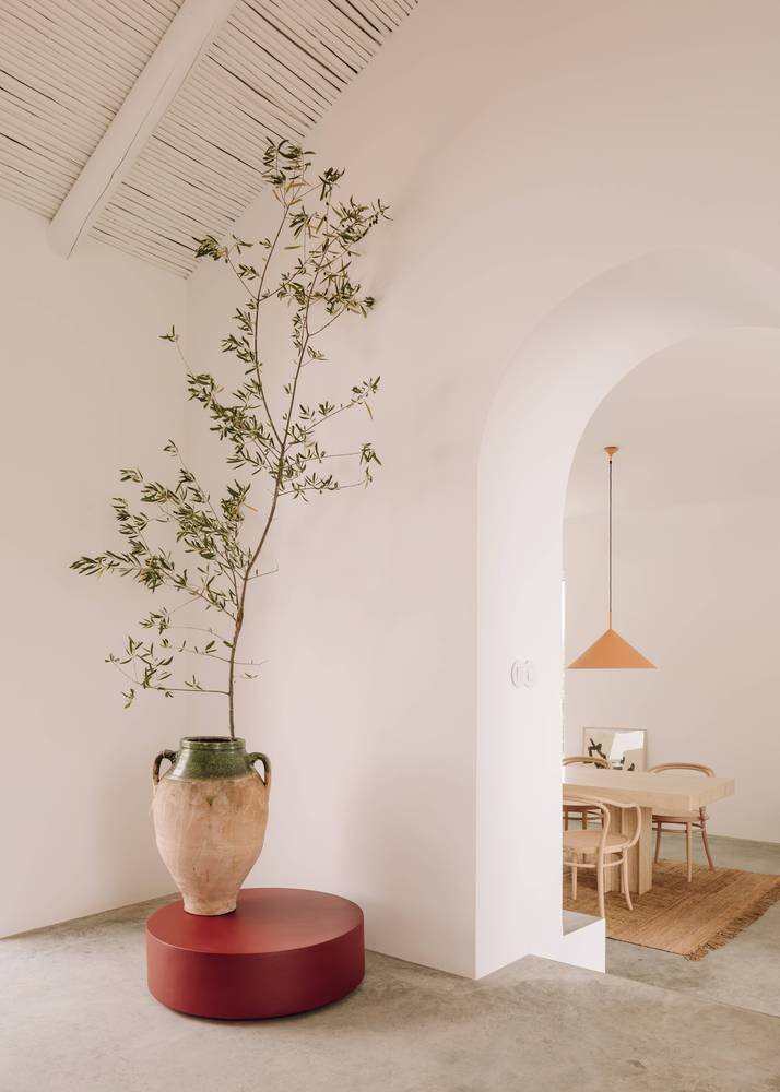 Casa de vacaciones en el algarve en Portugal con fachada e interiores de color blanco rincon con vasija de arcilla