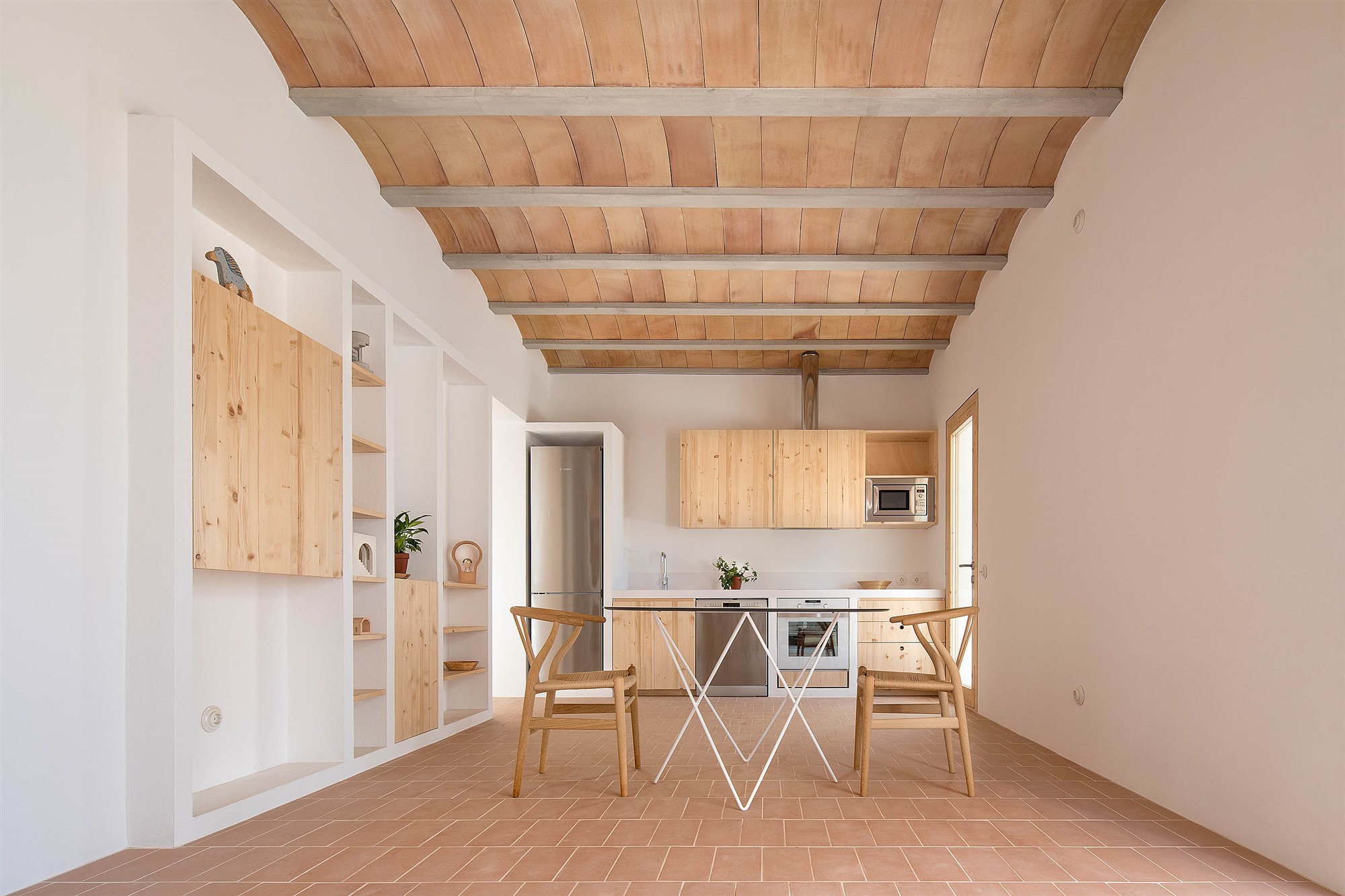 Casa blanca en Formentera del arquitecto Maria Castello comedor con suelo de barro