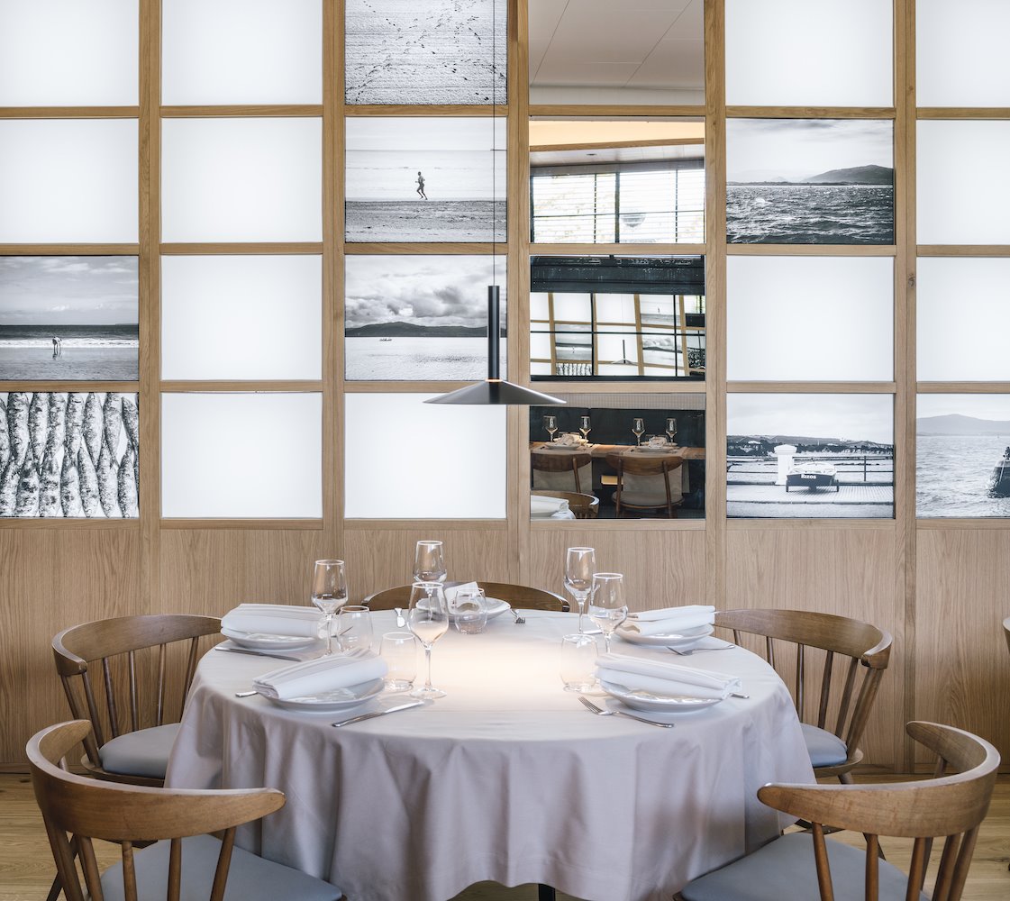 Restaurante La Maruca del estudio de arquitectura Zooco mesa redonda con lampara de techo negra