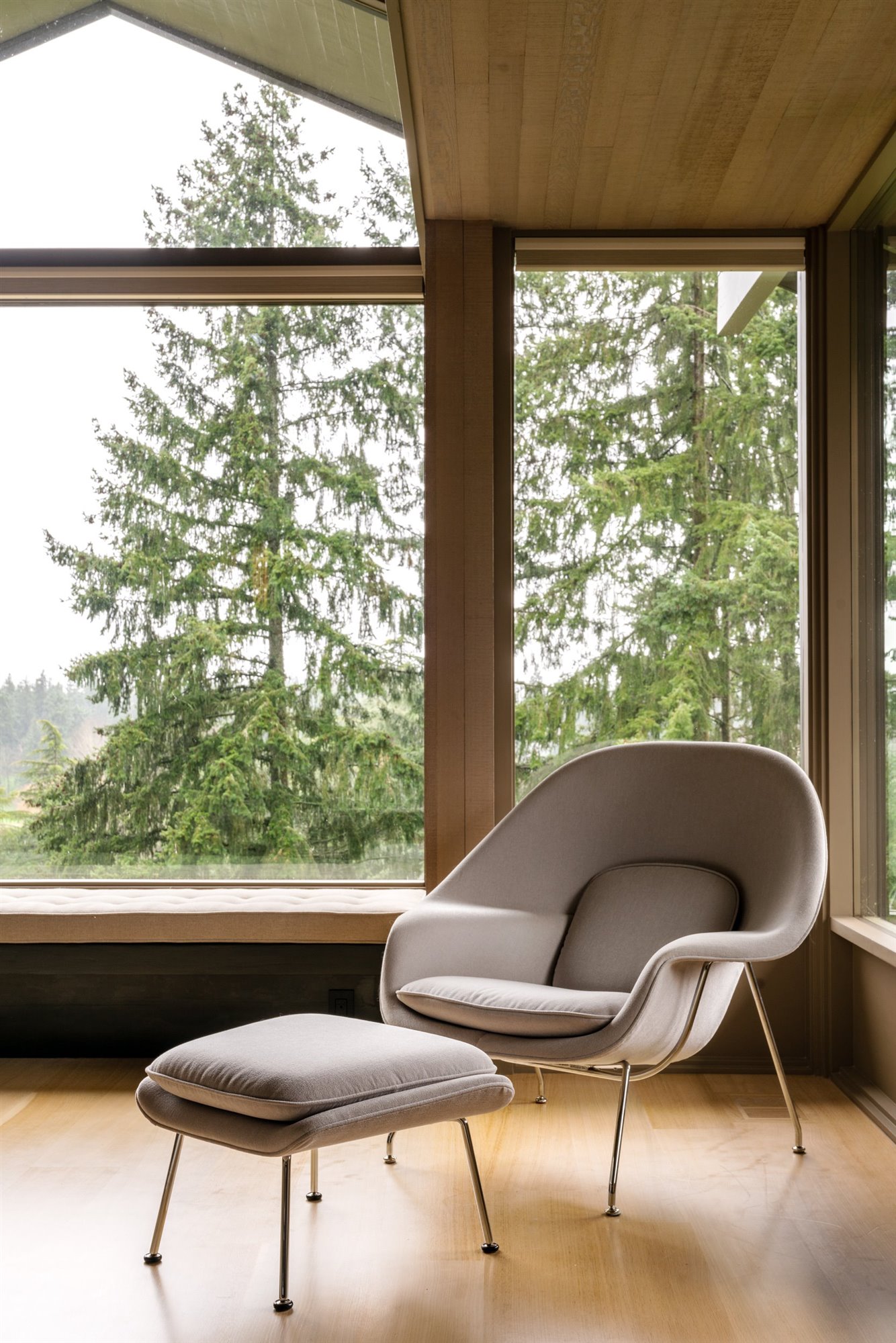 Casa moderna de madera con techo a dos aguas butaca junto a la ventana