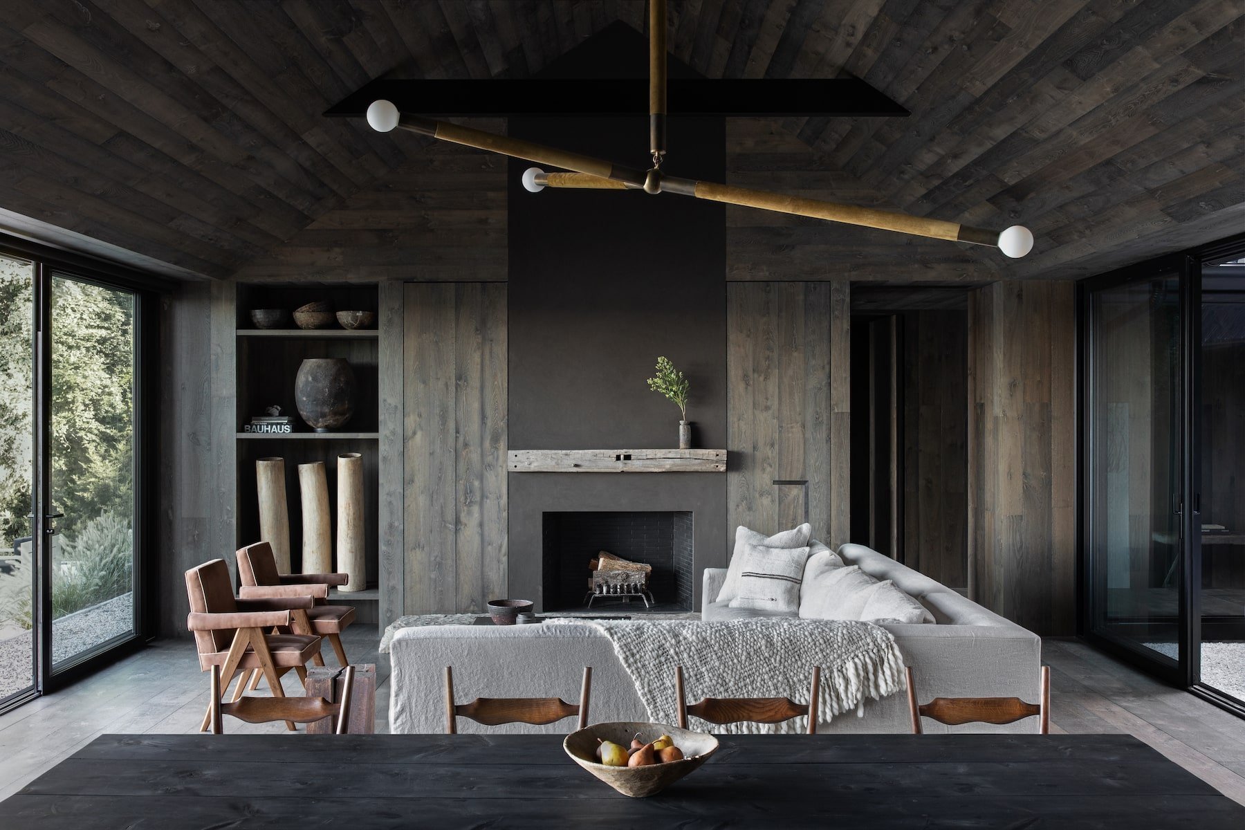 Casa en los Hamptons con fachada de madera en mitad del bosque salon con chimenea