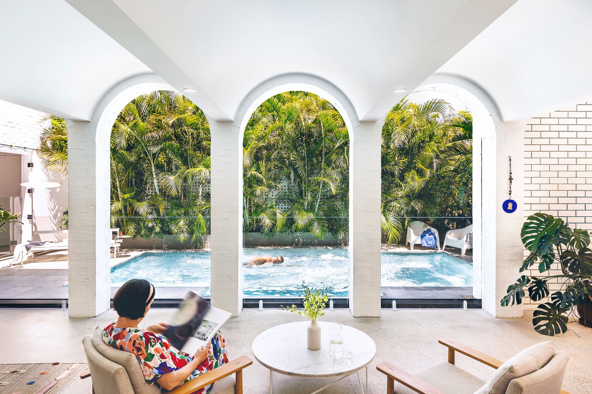 Casa de verano con piscina en Brisbane con fachada blanca porche con arcos