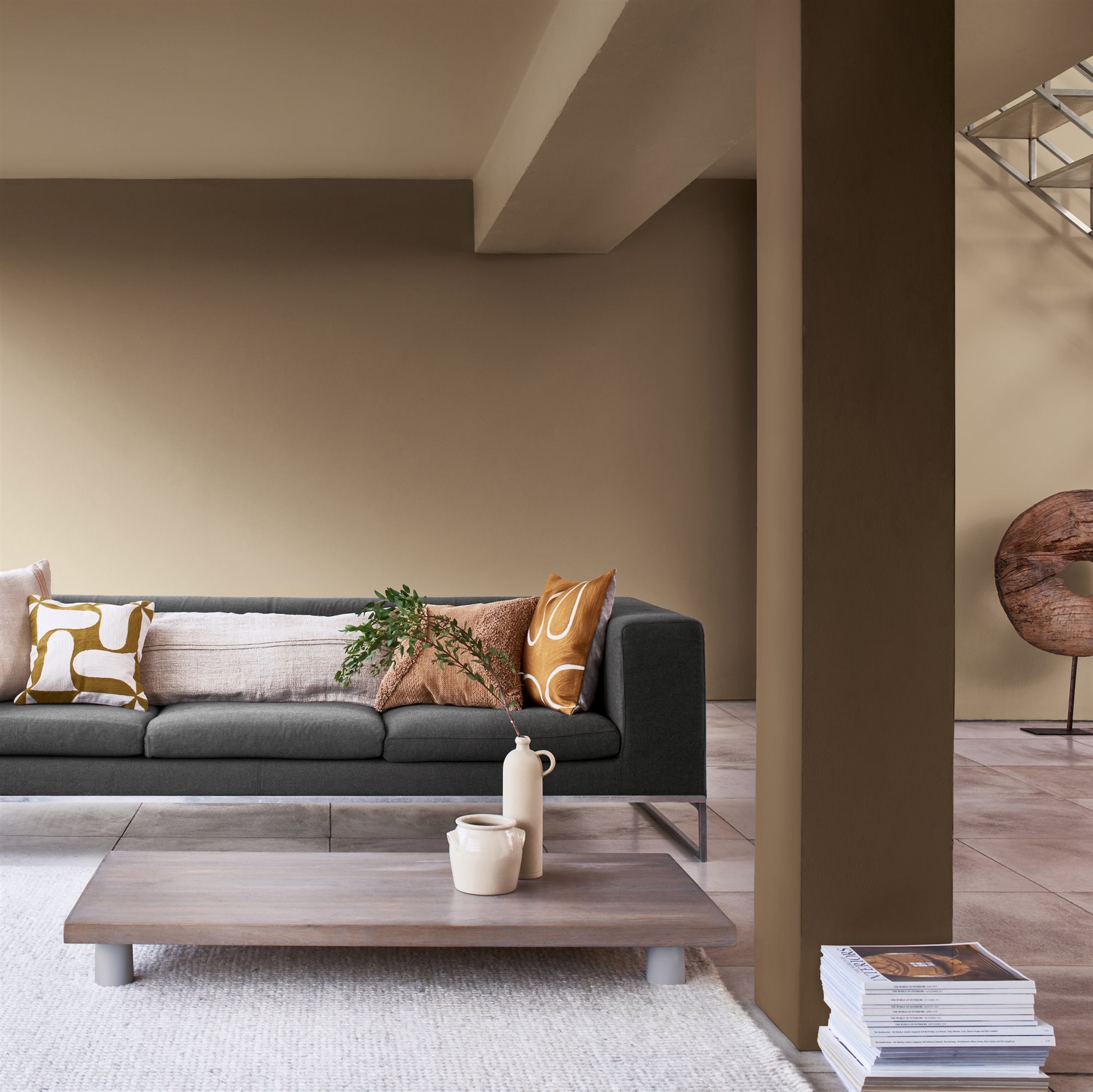 Living room with gray sofa and beige and brown walls