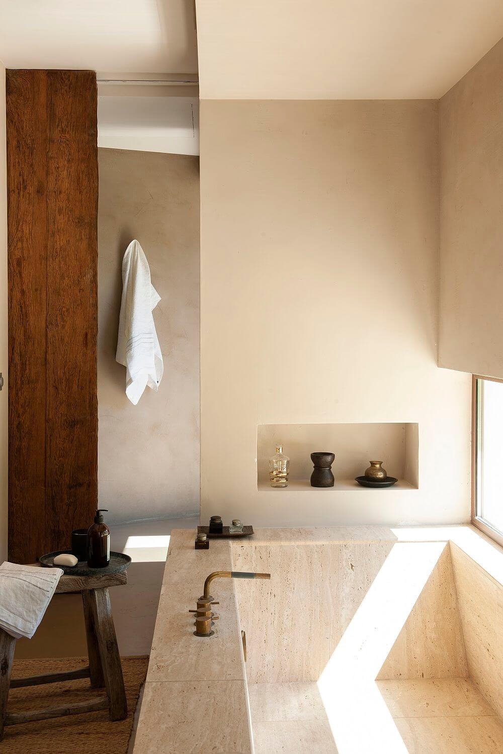 Baño de mármol Travertino con hornacina y puerta corredera.